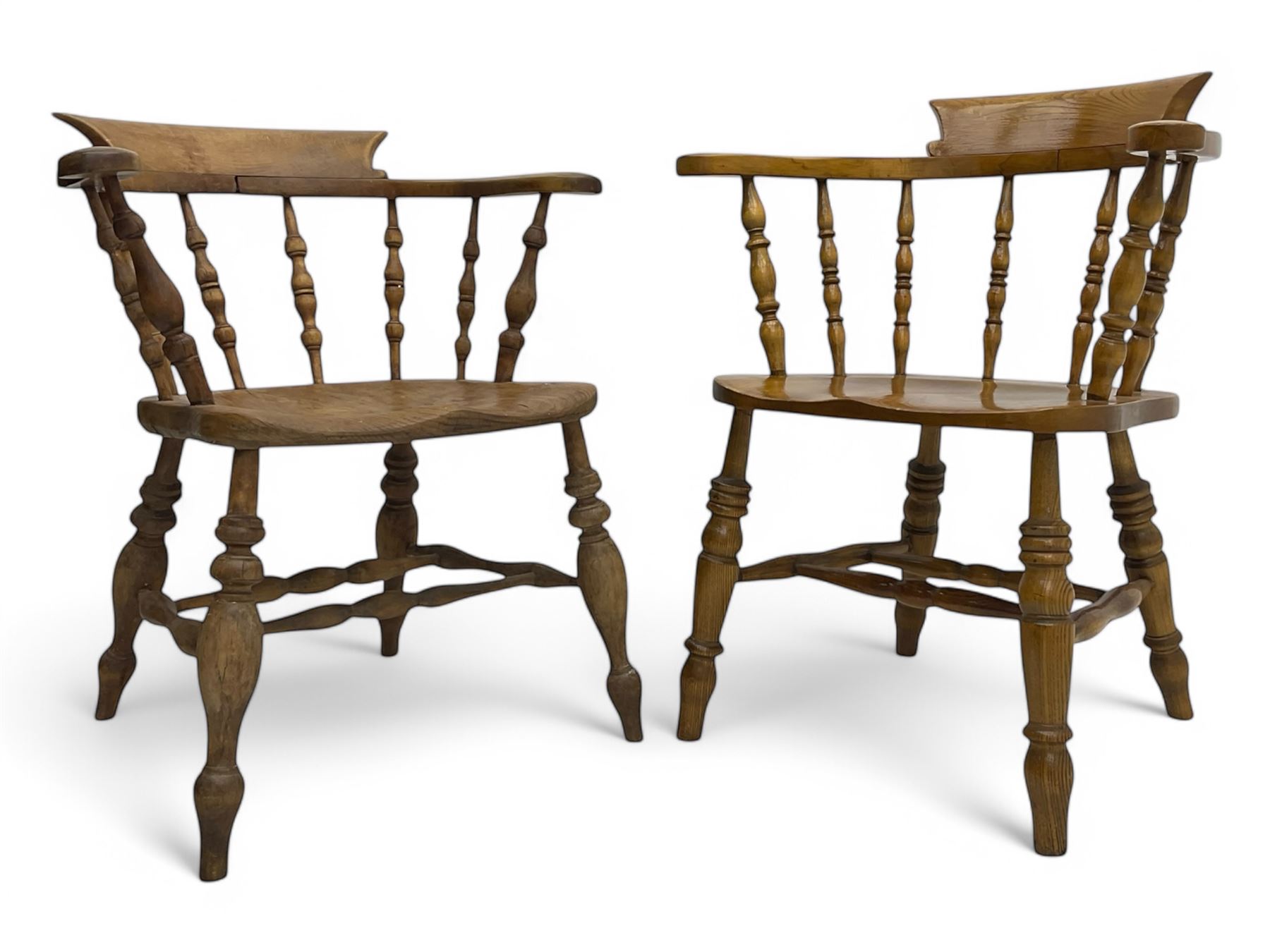 Late 19th century elm smoker’s bow armchair, curved top rails over turned spindle backs, shaped seats, raised on turned legs united by turned stretchers; together with a similar smoker’s bow armchair (2)