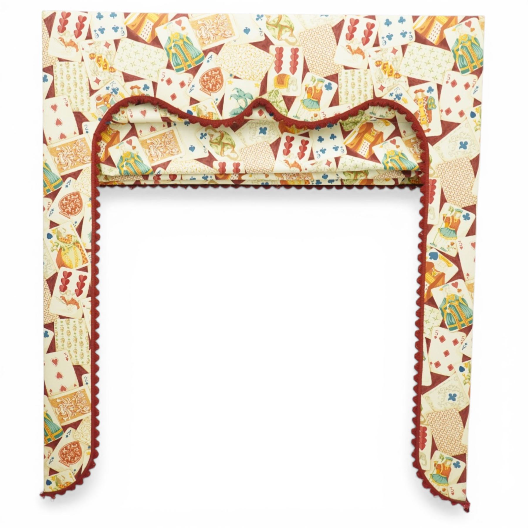 Late 20th century upholstered window pelmet with internal blind and side drapes, covered in a playing card patterned fabric with scalloped edging and red braid trim