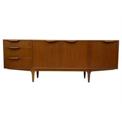Tom Robertson for AH McIntosh & Co of Kirkaldy - mid-20th century teak 'Dunvegan' sideboard, with three graduating drawers fitted cutlery divider, three cupboards one fall front each with recessed sculptural handles, raised on shaped and tapering supports