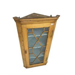 Early 19th century pine corner cabinet, projecting dentil cornice over astragal glazed door