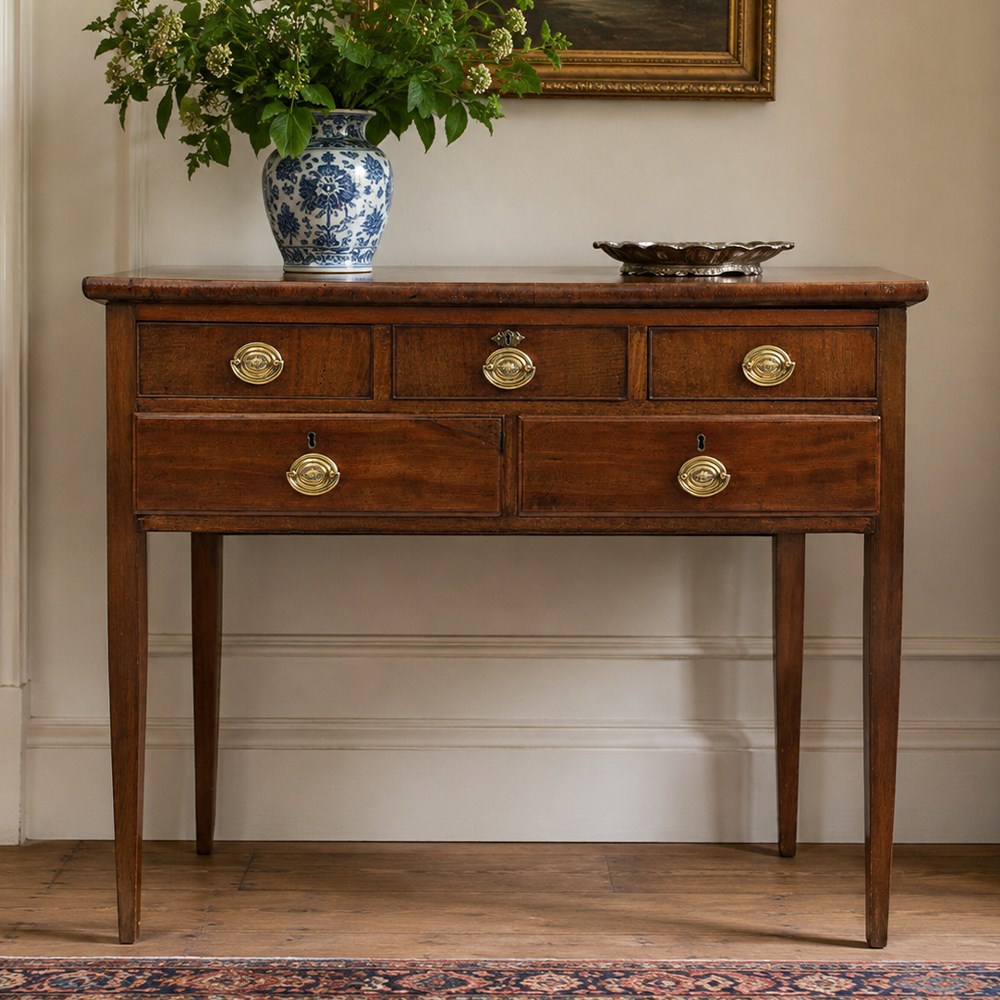 Georgian mahogany side table fitted with drawers, rectangular top over five drawers with brass handles, raised on tapering square supports