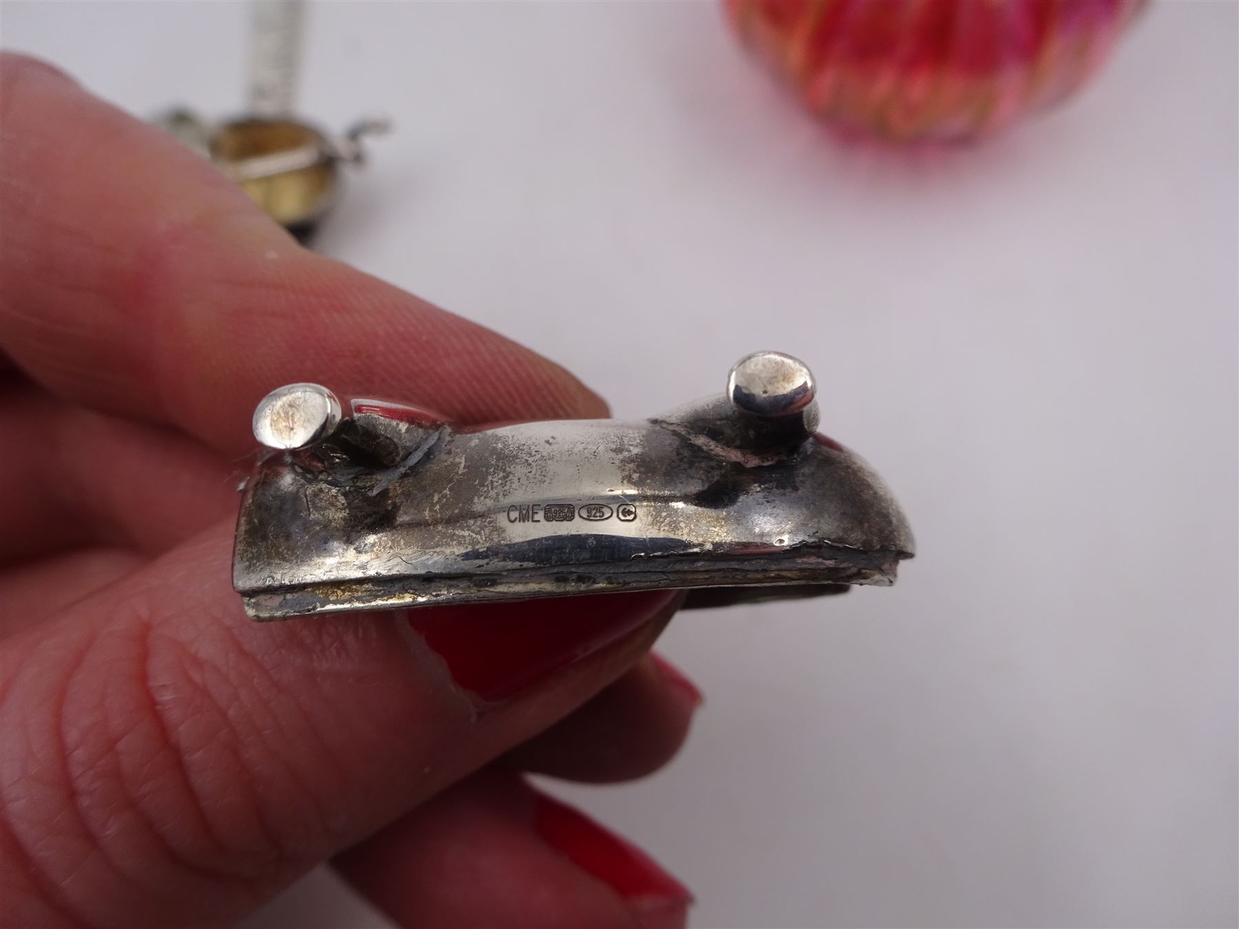 Modern novelty silver tape measure, in the form of a pig, hallmarked CME Jewellery Ltd, together with a silver mounted pink glass scent bottle, signed H. White to base, with silver collar hallmarked Laurence R Watson & Co, Birmingham 1996, scent bottle H12cm