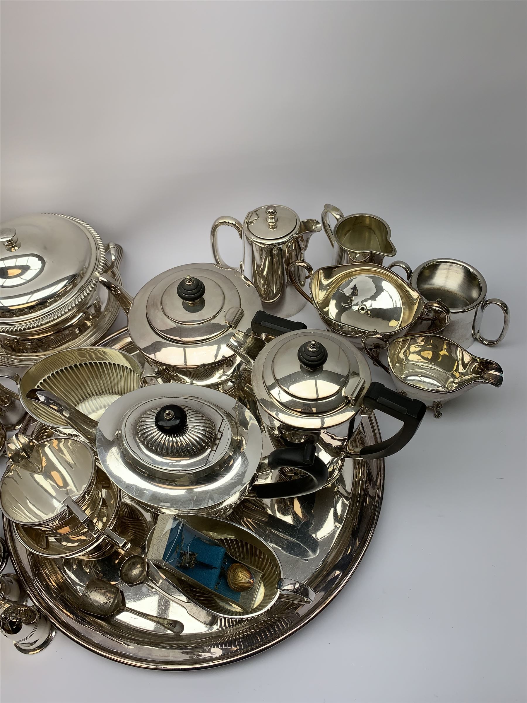 Mappin & Webb Art Deco style four-piece silver-plated tea set, a Mappin & Webb three-piece Princes Plate tea set of half fluted form with engraved monogram, two silver-plated entree dishes, circular tea tray, part cruets and other plated wares 