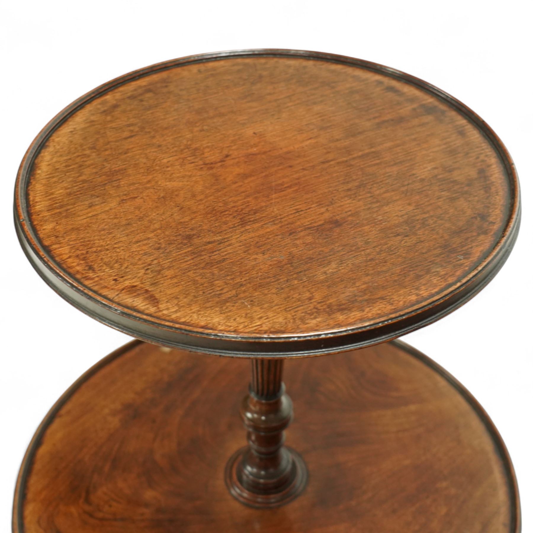 Regency mahogany dumb waiter, with two graduated circular tiers raised on a turned column and tripod base terminating in brass castors, circa 1820