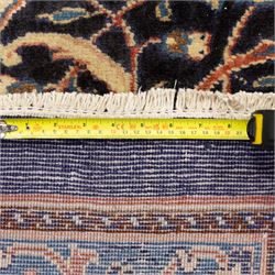 Large North West Persian Mahal hand-knotted carpet, central indigo field with a rosette medallion with an all-over design of scrolling vines and palmettes, framed by a brick red border of arabesques and flowerheads between sky blue and ivory guard stripes, with cotton fringe ends 