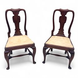 Pair of early 18th century walnut side chairs, vase-shaped splats beneath shaped top rails...