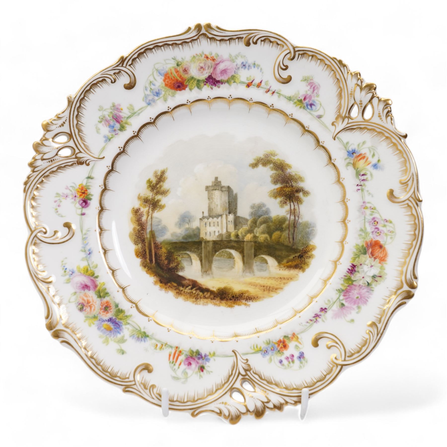 H&R Daniel Queen's shape porcelain plate, centrally painted with Blarney Castle, within a polychrome floral painted border, titled beneath, D25cm and another plate painted with a view of Warwick Castle (2)