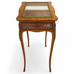 Louis XV revival style walnut bijouterie table, rectangular serpentine form, with brass edging and a hinged floral marquetry inlaid lid with bevelled glass top and sides, gilt-bronze beaded border, interior lined with rich red velvet, raised on slender cabriole legs with gilt bronze masks and sabots, circa 1900