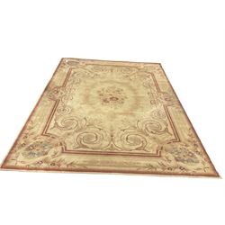 Beige ground rug, central medallion, repeating boarder 