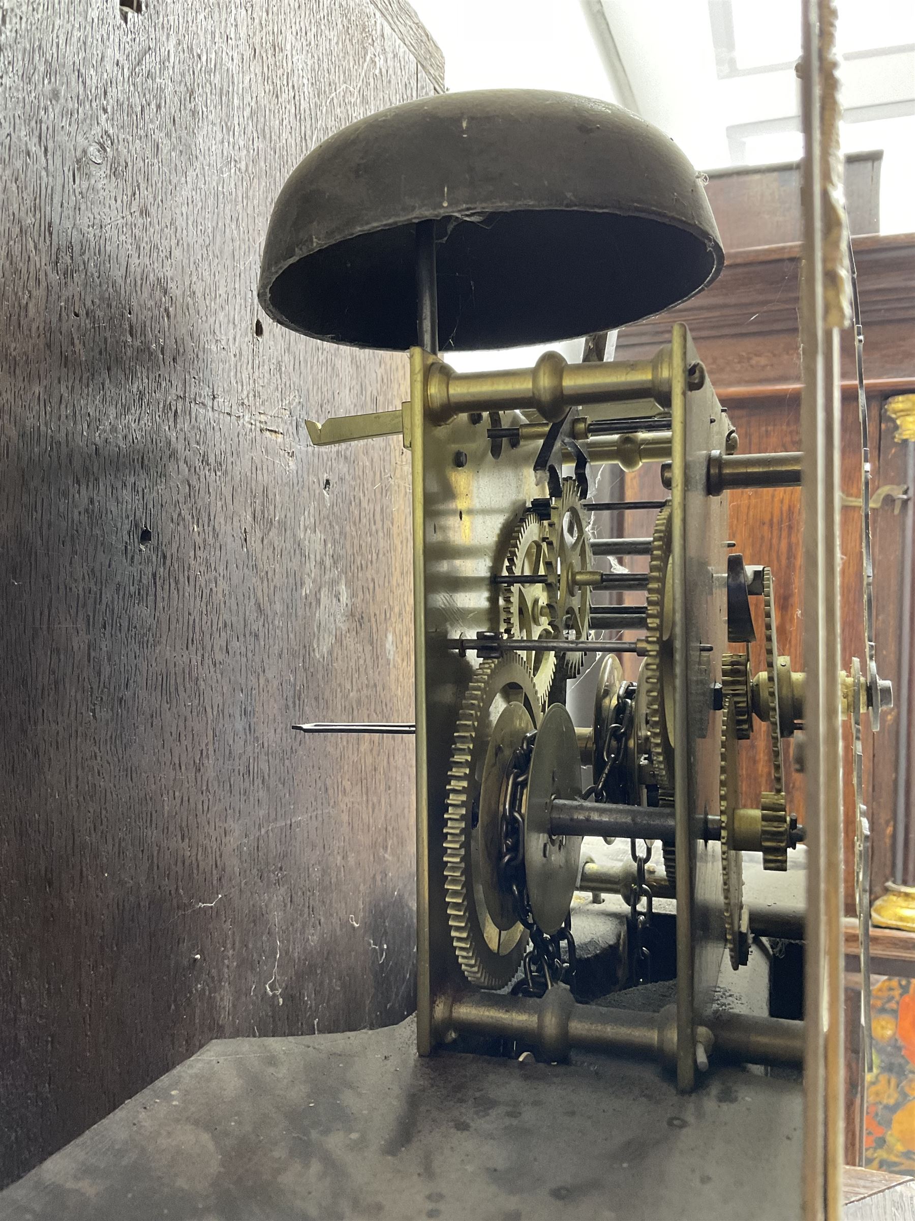 Victorian Jacobean revival oak cased 30 hour longcase clock - with a carved pediment and break arch door beneath, door with attached pilasters and gesso capitals, break arch trunk door with a carved grotesque, conforming carved plinth raised on ball feet, brass dial with spandrels, matted centre and chapter ring, dial pinned to a chain driven countwheel movement, striking the hours on a bell.
With weight and pendulum.