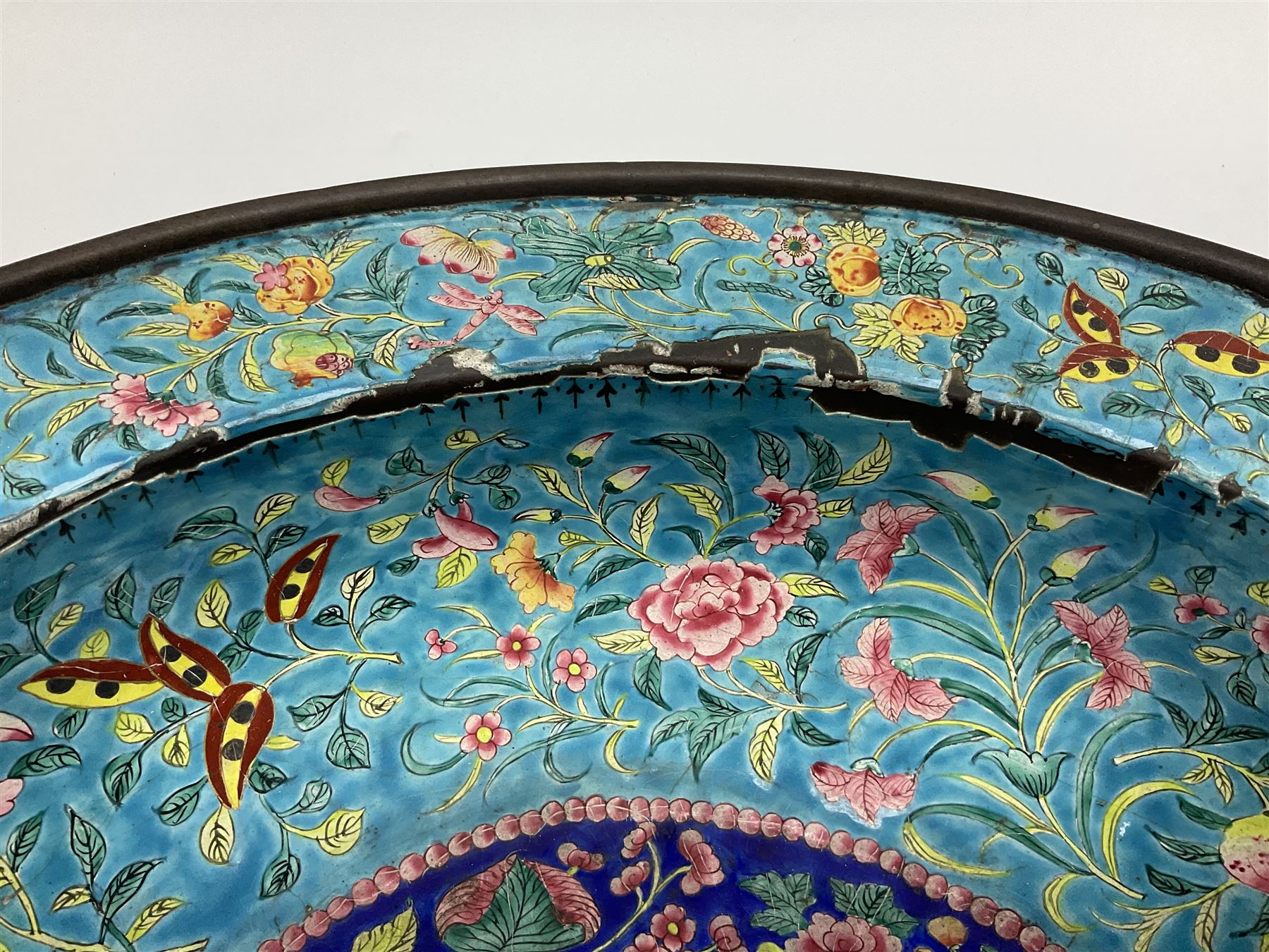 18th/19th century Chinese Canton enamel basin, the circular basin with flat everted rim, decorated with scrolling foliate and fruit decoration on a blue ground, D43cm
