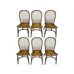 Set of six elm Windsor chairs, stick and hoop back, saddle seats with crinoline stretcher base