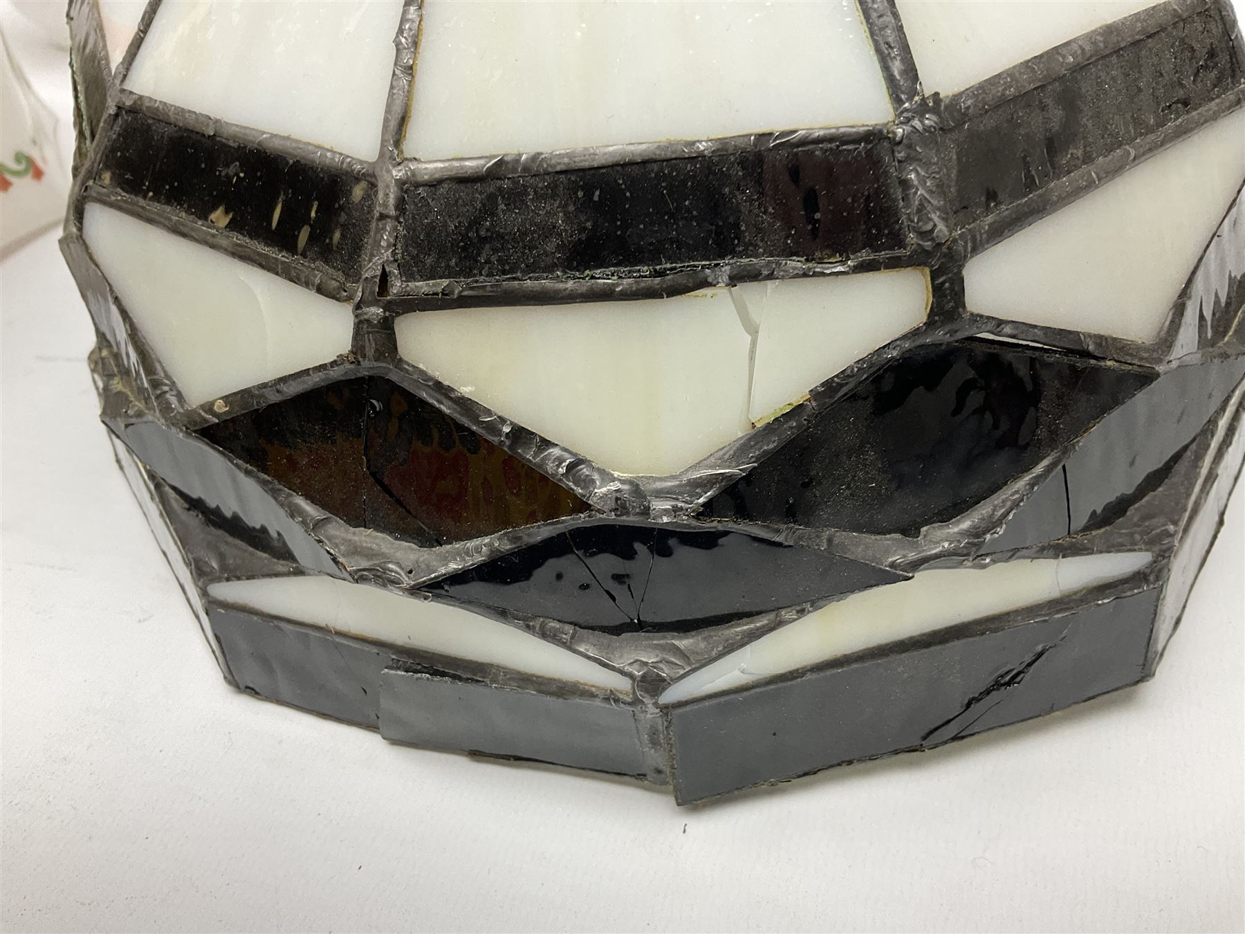 Milk glass lampshade decorated with peacocks, together with a Tiffany style lampshade, a set of five white frilled lamps shades etc 