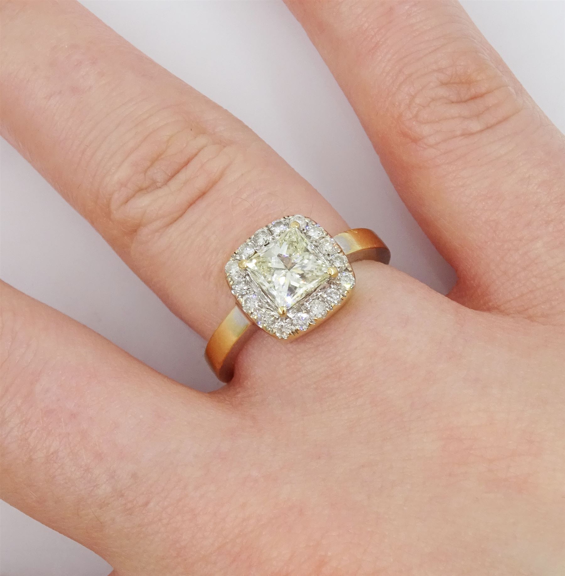 18ct gold diamond cluster ring, the central princess cut light yellow diamond of approx 1.00 carat, with round brilliant cut white diamond surround, total diamond weight 1.31 carat