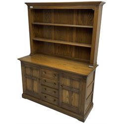 Ercol - mid-20th century dark elm 'Old Colonial' dresser, two tier plate rack with fluted uprights, base fitted with four drawers flanked by two panelled cupboards