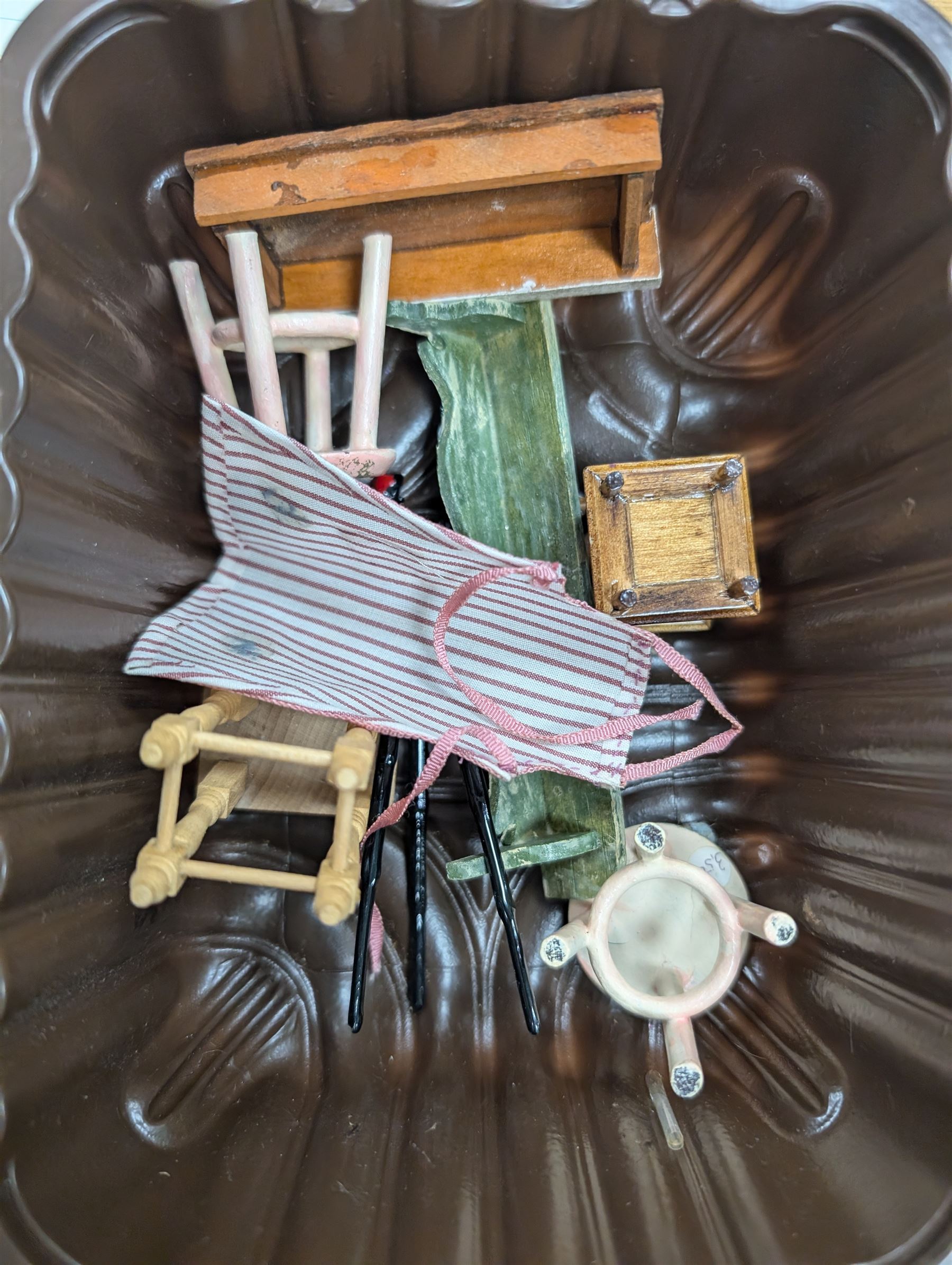 Two modern three storey dolls houses, each painted green with decorated interiors, both upon a single white wooden base, together with a large collection of dolls house furniture, accessories and figures 