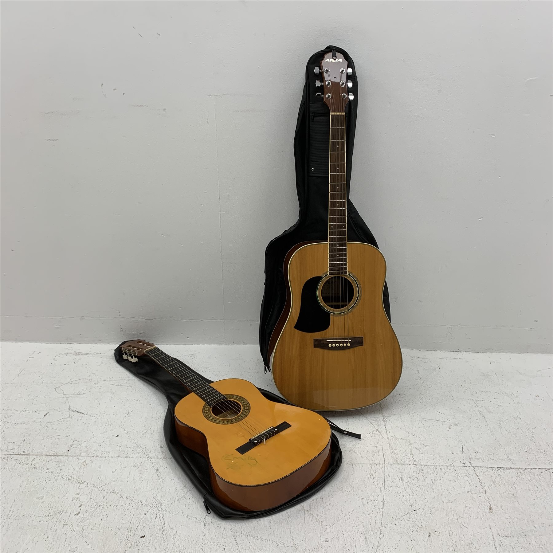 An acoustic Aria guitar, model no AW-20- LH N, together with a 3/4 acoustic Herald guitar, model MG104N. (2). 
