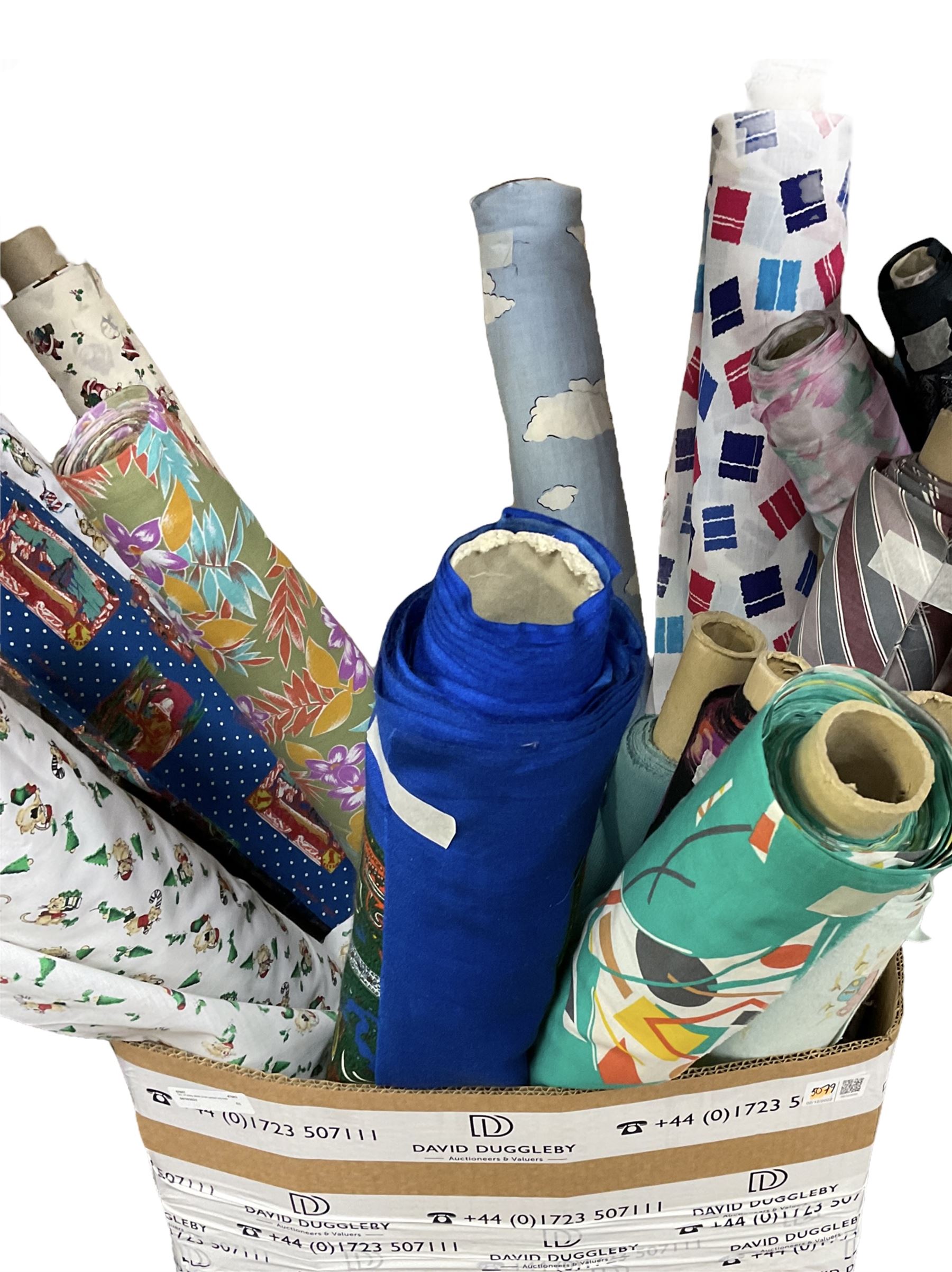 Haberdashery Shop Stock: Various rolls of fabric including metallic printed stage satin, abstract and geometric patterns, children's and festive fabric, and others (qty) in two boxes