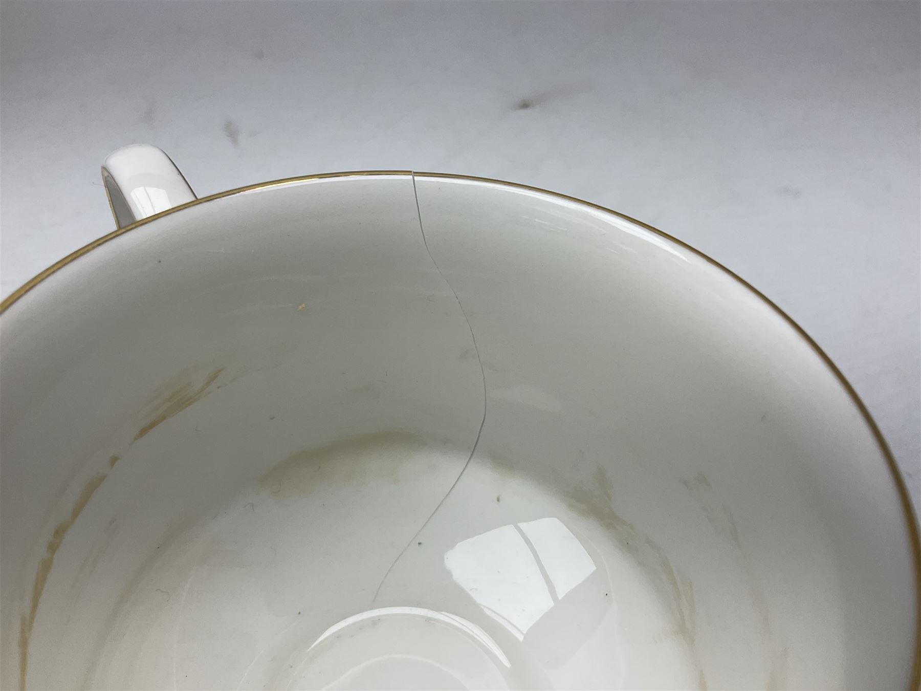 Royal Albert Paragon tea and dinner service for twelve decorated in the Belinda pattern, comprising fourteen saucers, twelve teacups, thirteen side plates, teapot, sauce boat and stand, salt and pepper shakers, two jugs, sucrier, twelve dinner plates, twelve smaller plates, two lidded tureens, twelve bowls, twelve smaller bowls, cake plate, oval plate and oval dish (100)