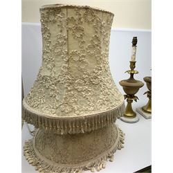 Three table lamps, of urn form with acanthus detail, two upon square base, the other upon circular base, (a/f), approximately H56cm, together with a pair of cream lace lampshades. 