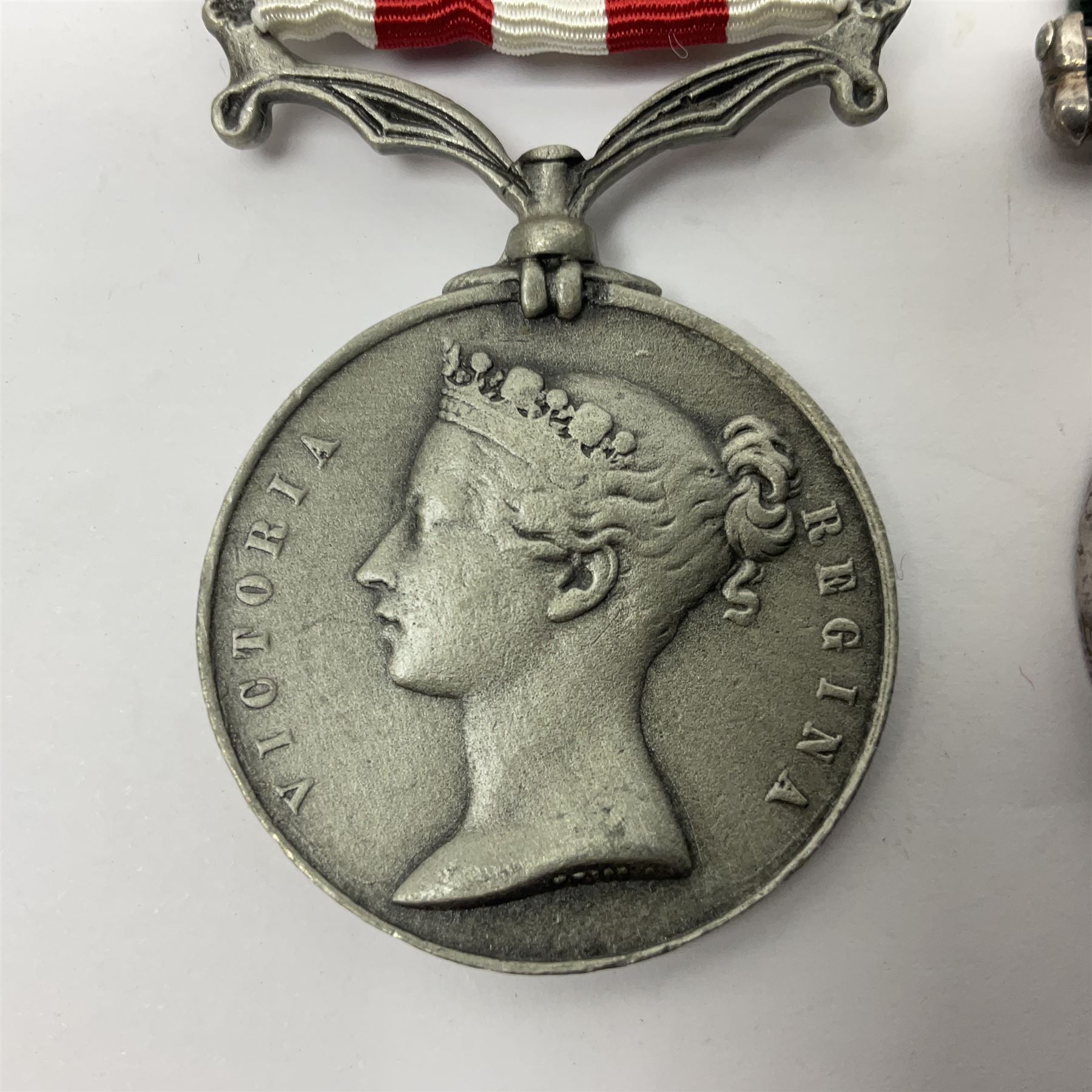 Victoria Long Service in the Volunteer Force Medal awarded to 369 Bombr. W. Woodward 1st Lincs. V.A.; and reproduction Victoria India Medal with Lucknow clasp; both with ribbons (2)
