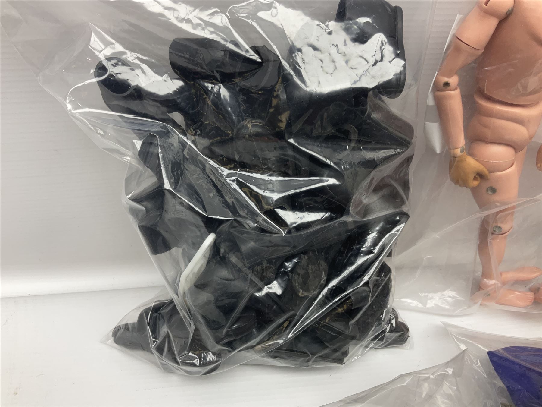 Action Man - large collection of 1960s and later figures and accessories including Spaceman with ATLRV vehicle; two figures marked 'Made in England by Palitoy under licence from Hasbro 1964'; twenty-five assorted weapons; radio backpacks; kit bags; twenty-one pairs of boots; football boots and snow shoes; metal diver's boots and three pairs of flippers; two pairs of jackboots; roller skates; various tunics, trousers, flying suits, jumpers, belts etc; twenty helmets, berets, busby, kepis, submariner etc; and quantity of other accessories