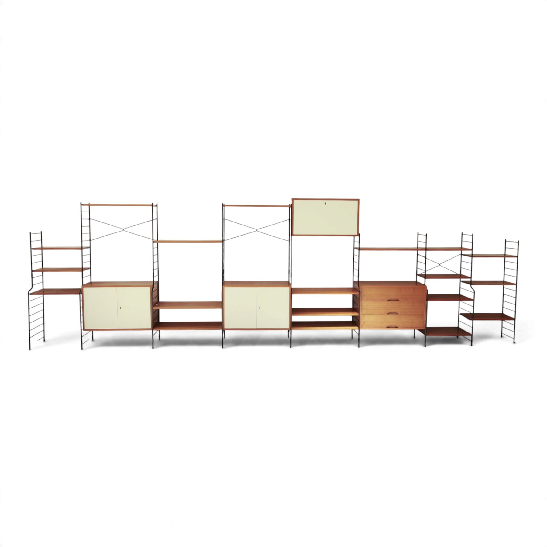 WHB - 'Ladderax' 1960s German modular shelving wall unit, comprising two teak cabinets with white doors, a further fall front teak cabinet with white front, a drawer section with three drawers with recessed handles, multiple shelving sections, raised on metal ladder frames, with further spare sections

Cabinet units: H 47cm, D 36cm, W 71cm
Fall front unit: H 40cm, D 26cm, W 71cm
Shelve widths: 50cm, 71cm 
Shelve depths: 26cm, 36cm