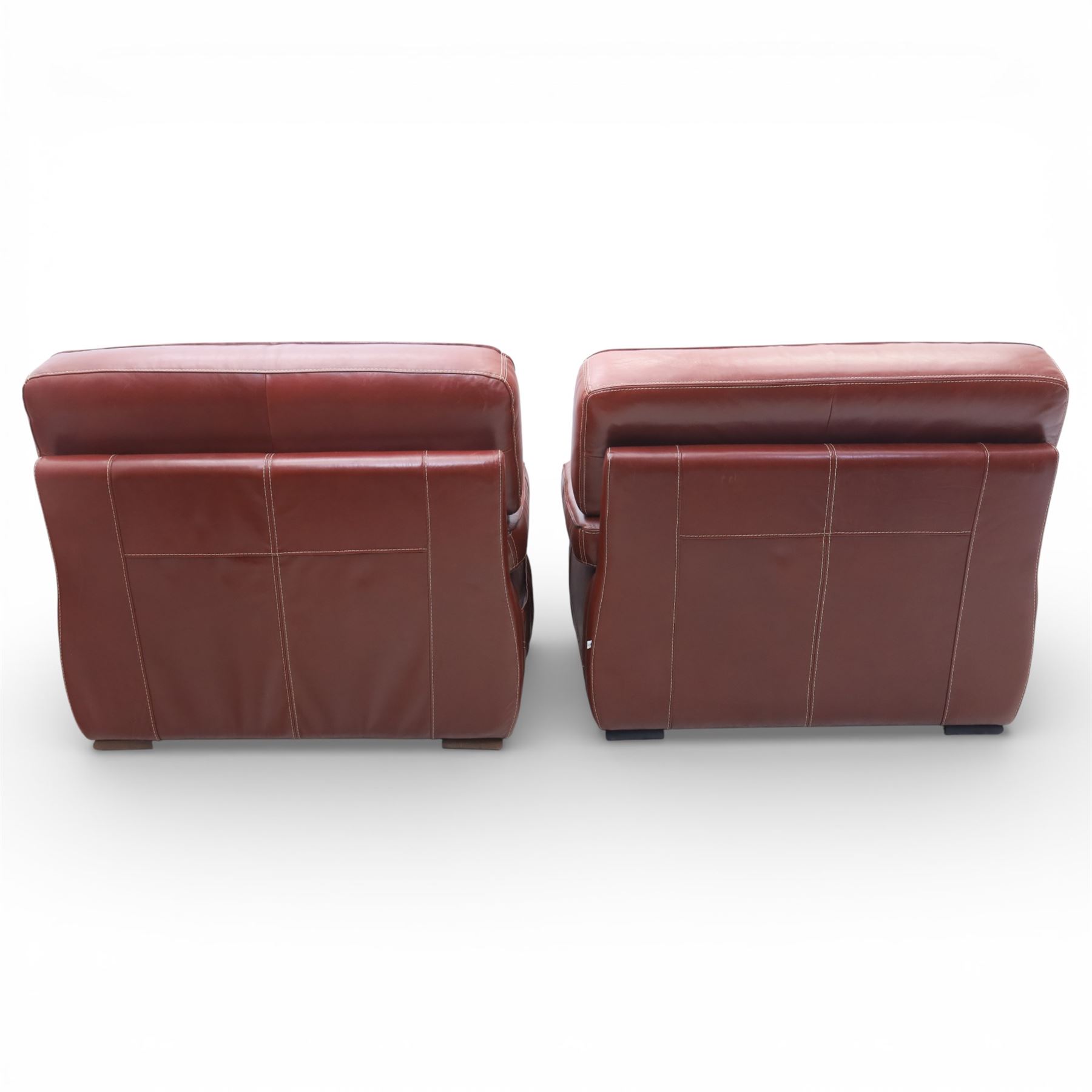 Fabrizio Mantellassi - 20th century Italian red leather suite, one three seat and two large armchairs, upholstered in deep red hide with stitched seam detailing, with magazine pockets to each side, the rectangular back cushions above broad padded arms and seat cushions, raised on low block bases

Sofa: H c98m, W 203cm, D 92cm
Armchair: H 98cm, W 113cm, D 92cm