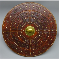  Replica Scottish Highlander's Targe by Joe Lindsay, based on an original targe traditionally known as 'Lord Lovats Targe', the wooden shield covered in tooled leather with traditional Celtic designs, brass studs and mounts with deer skin hide verso, D49cm   