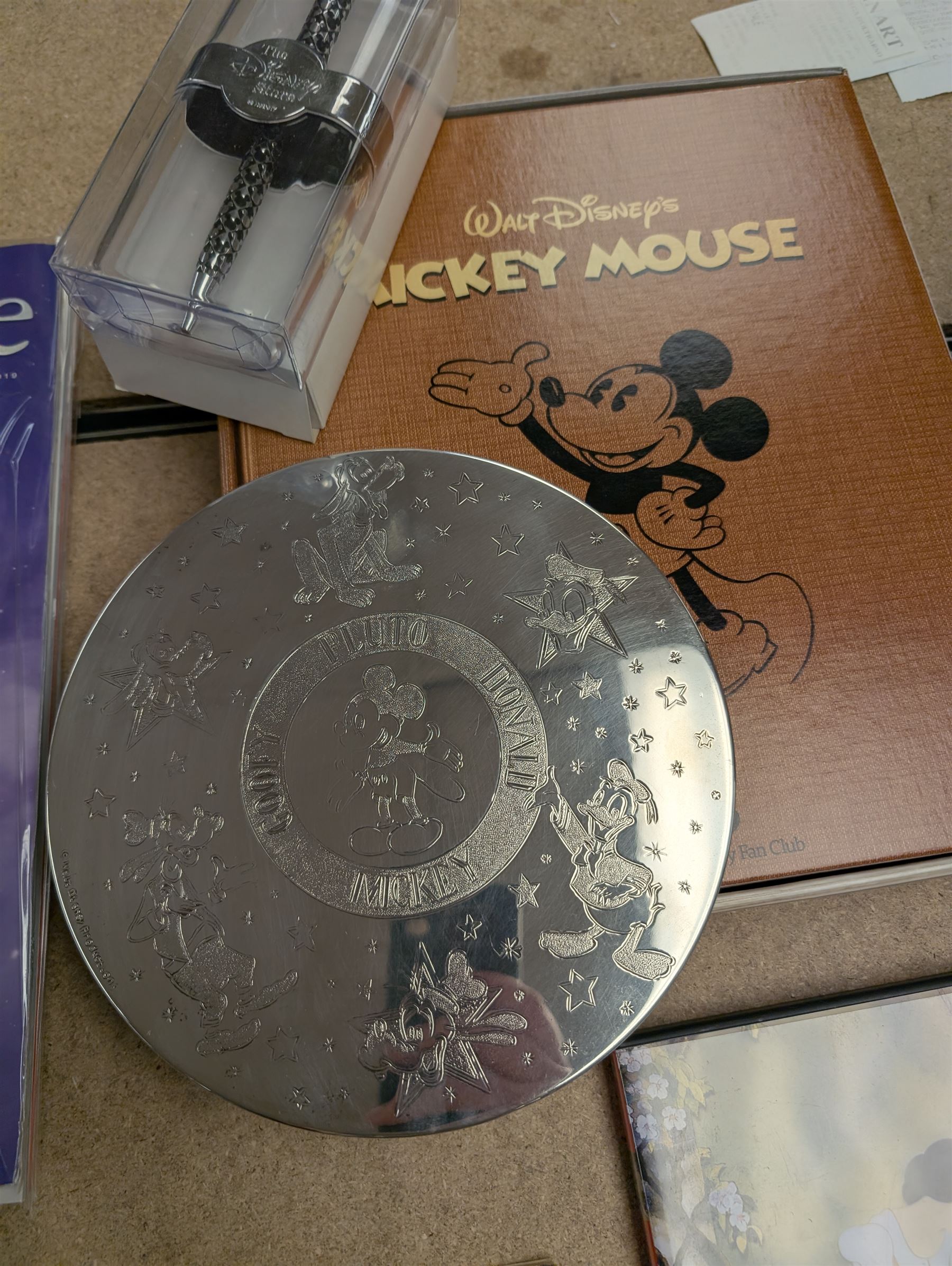 Collection of Disney memorabilia and ephemera, including Walt Disney Treasures DVD, two Disney Villains mugs, enamel pins, Mickey Mouse D23 fan club pack, Disney Twenty-Three magazines, Sketches magazines, etc