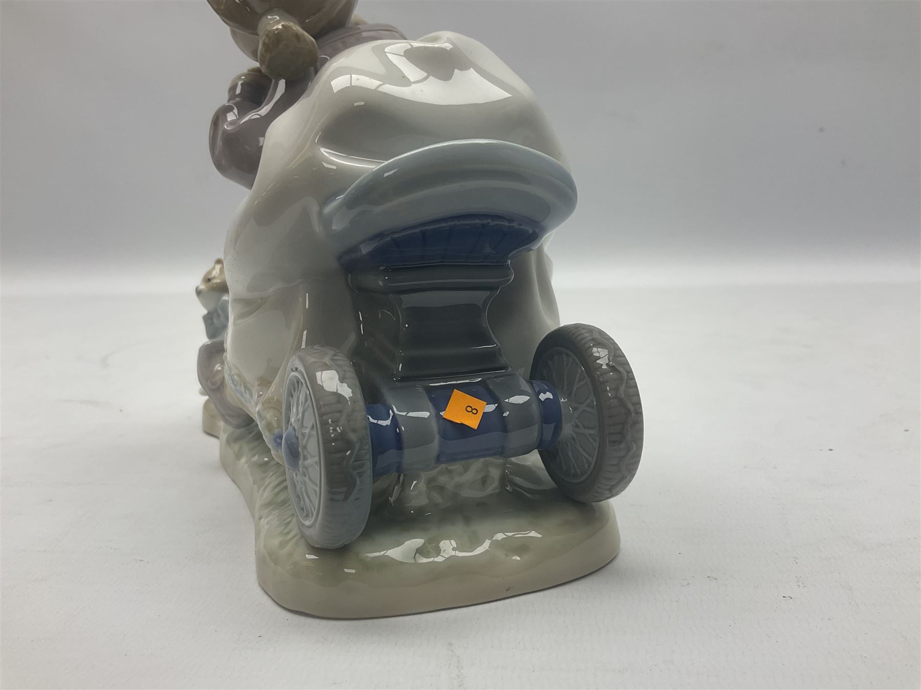 Lladro figure, In No Hurry, modelled as a girl on a tricycle, sculpted by Francisco Polope, with original box, no 5679, year issued 1990, year retired 1994, H15cm