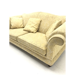 Licoln House three seat sofa, upholstered in a pale gold chenille fabric with floral pattern, shaped back, scrolled arms on turned supports, W200cm