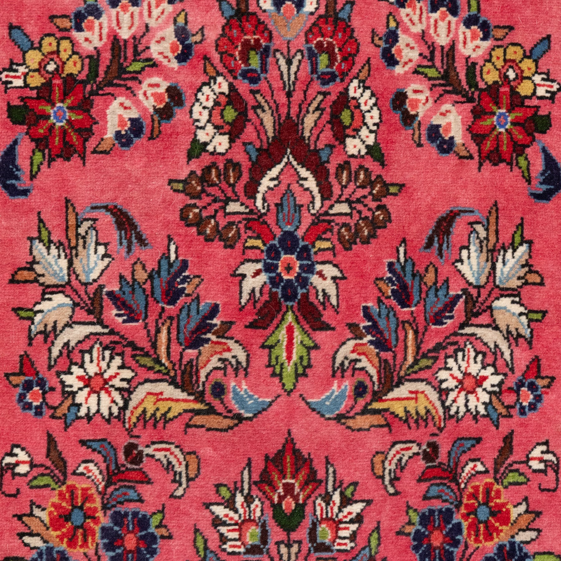 Persian rose ground runner rug, the field decorated with repeating polychrome floral sprays and scrolling palmettes, enclosed by an ivory floral border and narrow navy geometric guard stripes