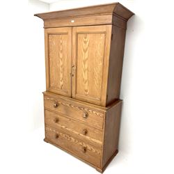 Victorian scumbled pine linen press cupboard, projecting cornice above two doors enclosing two shelves above three graduating drawers 