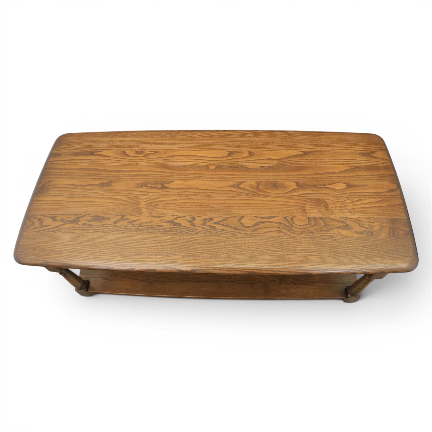 Ercol -  dark elm corner TV stand and coffee table, TV stand with drop triangular leaf, over open recess above a single drawer (H 47cm, D 44cm with leaf 79cm, W 73cm,  the coffee table with chamfered rectangular top with full length undertier, raised on turned supports (H 43cm, D 54cm, W 115cm) 
