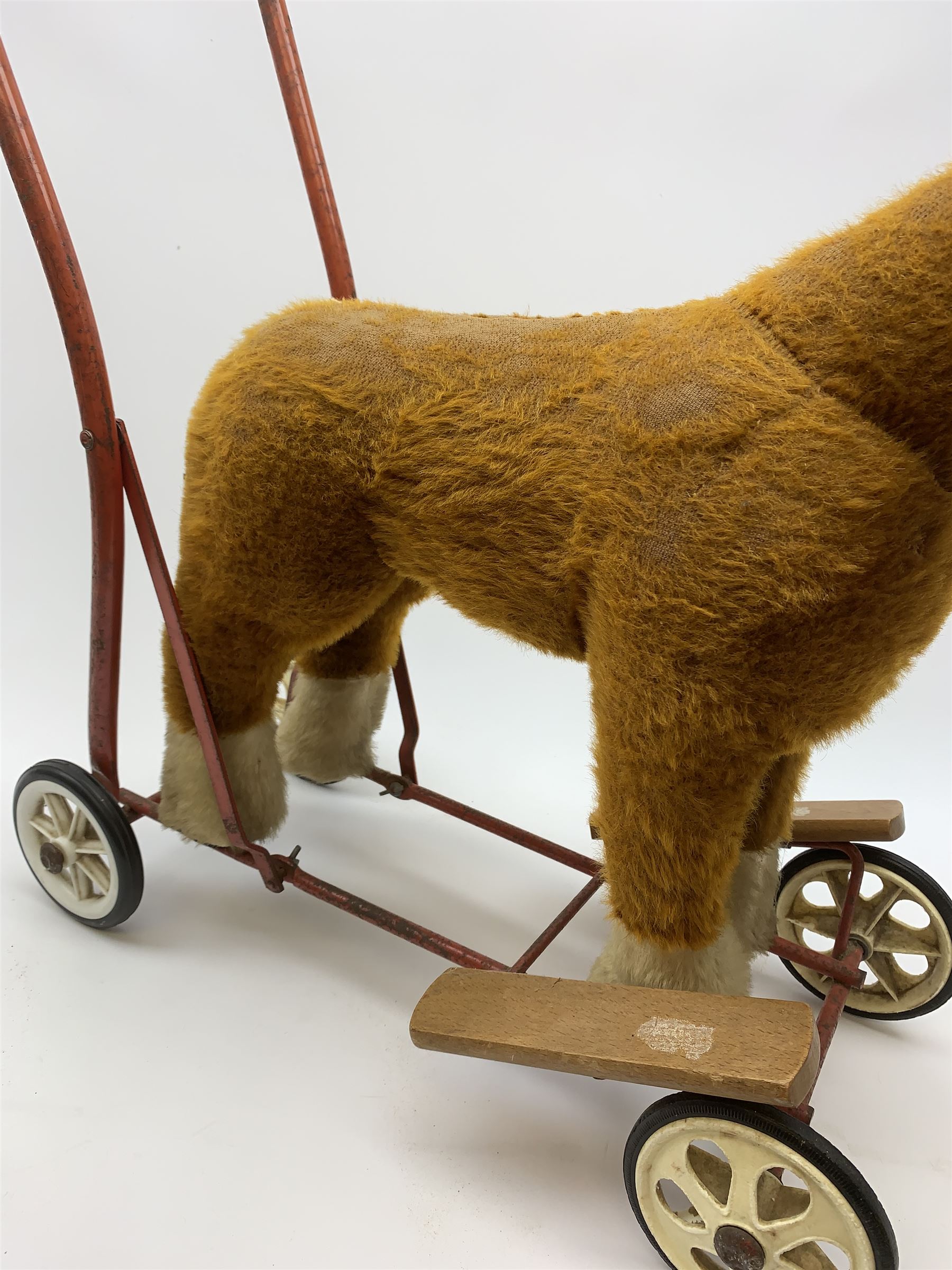 Pedigree push along plush covered horse 1950s-60s with red tubular metal framework and beech foot rests H25
