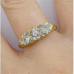 Early 20th century gold three stone old cut diamond ring, with eight diamond accents set between, stamped 18ct, central diamond approx 0.50 carat, total diamond weight approx 0.95 carat