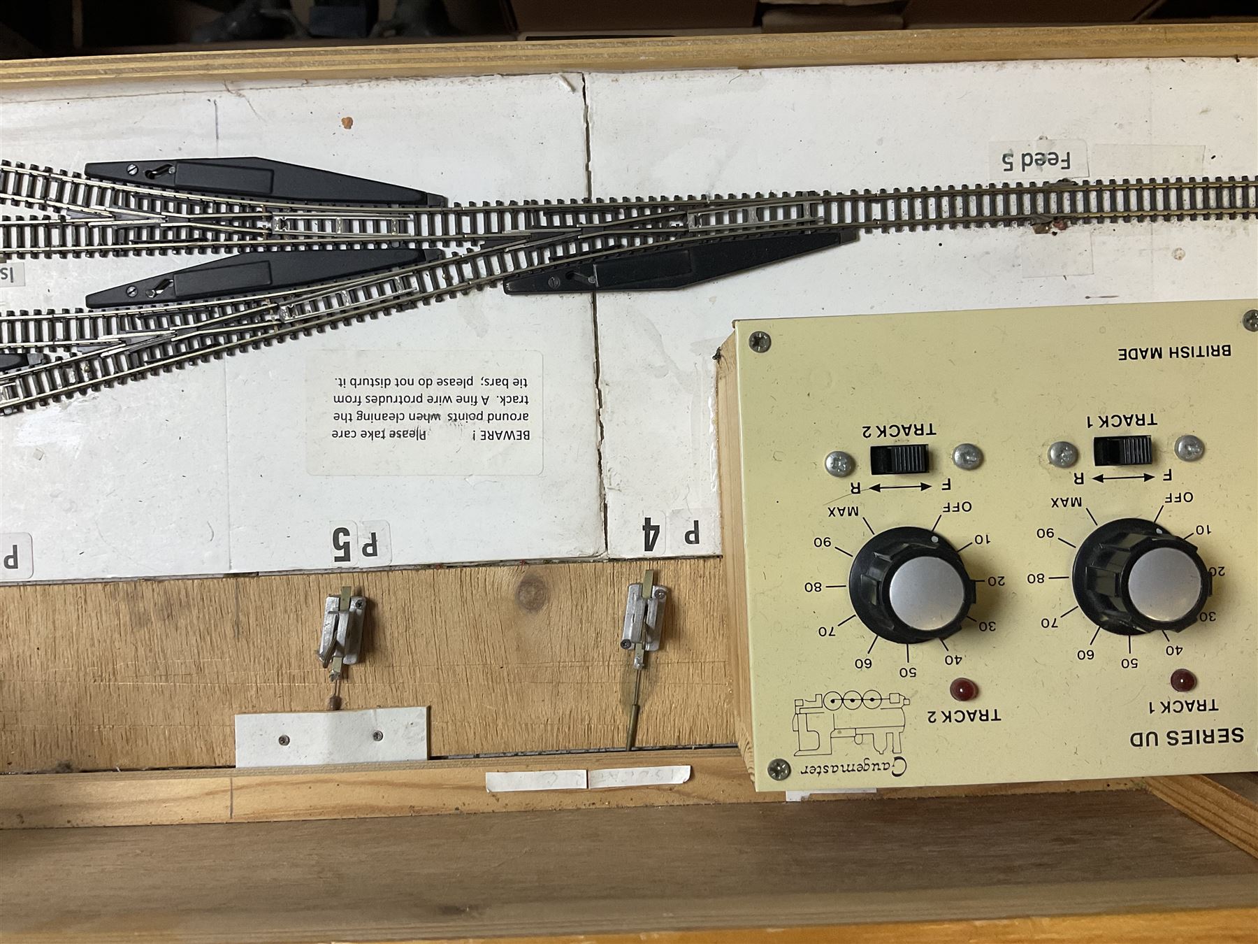 'Z' gauge continental scenic layout with folding legs, various loops of track and sidings with overhead cables, buildings including water tower, tunnels, roads with motor vehicles and figures, trees, haven with boats, backdrop diving wall hiding control units 150 x 50cm