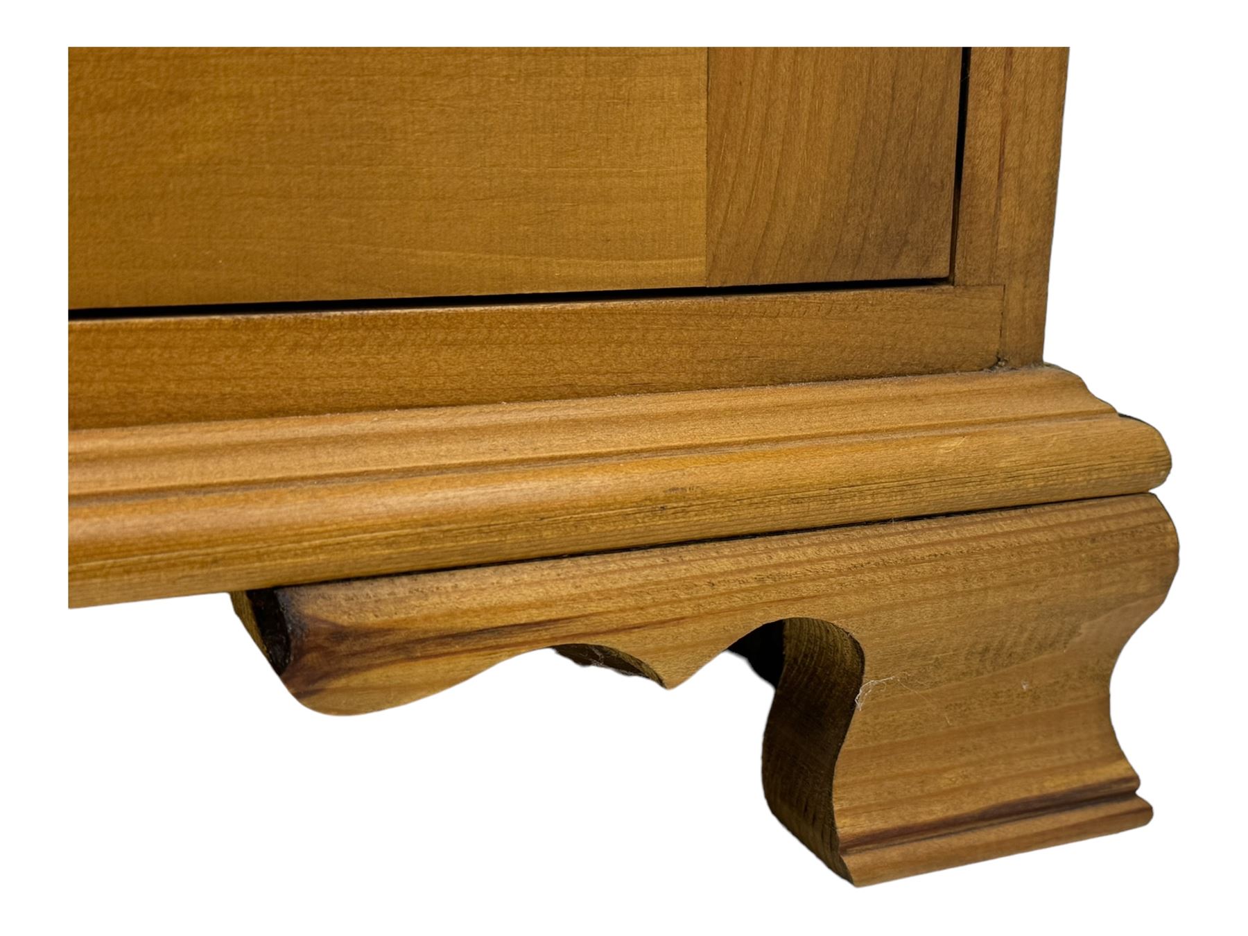 Pine chest of drawers topped with carved pediment with acorn and oak leaf motif, fitted with two short over three long drawers, standing on shaped apron base (W92, D46, H97cm); pine bedside cabinet, single drawer above paneled cupboard door enclosing open storage, shaped plinth base (W43, L32, H67cm)