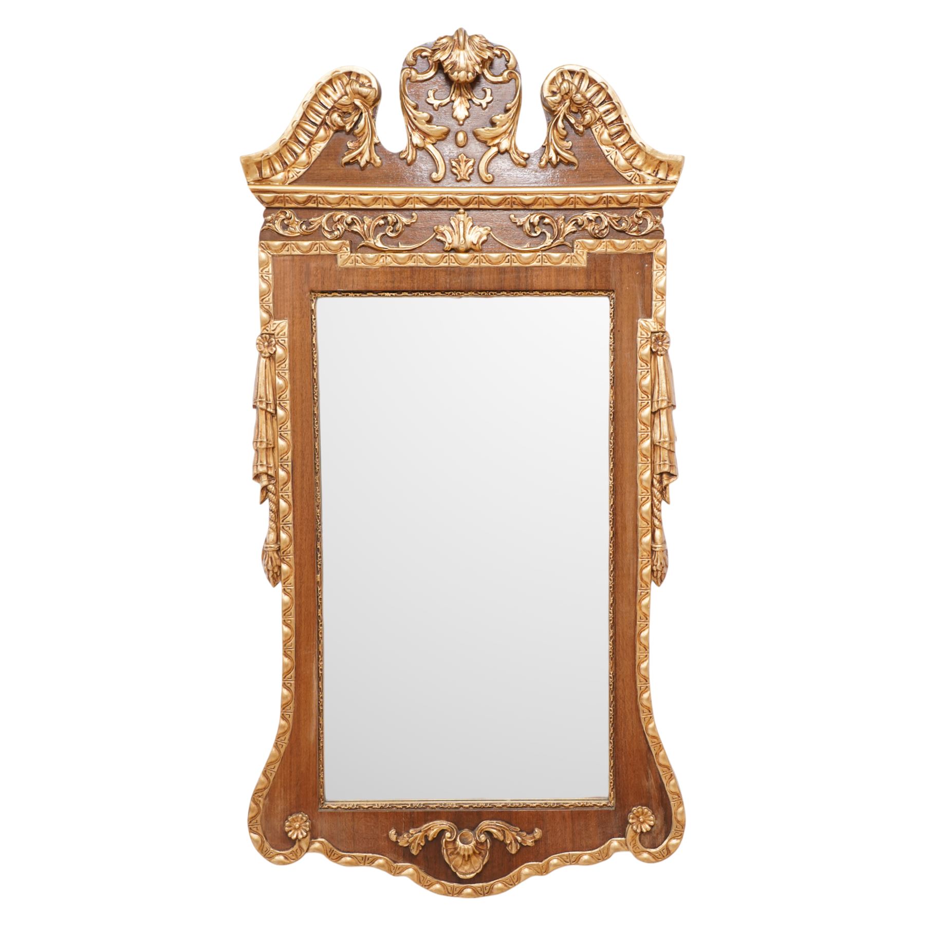 20th-century ornate gilt and mahogany Chippendale style wall mirror, the wooden gilt-edged frame with applied scrollwork with foliate motifs, drape, and tassel decoration 
