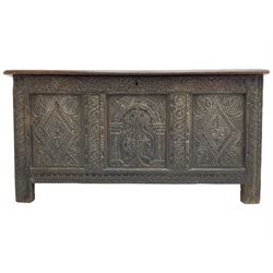 18th century oak coffer, the triple panelled hinged lid with moulded frame over triple panelled front, foliate arcade carved frieze rail, two lozenge carved panels with foliage corners, central arch carved panel with scrolling foliate and pillars, foliate carved rails and double panelled sides decorated with pointed arch and roundel carvings, on stile supports
