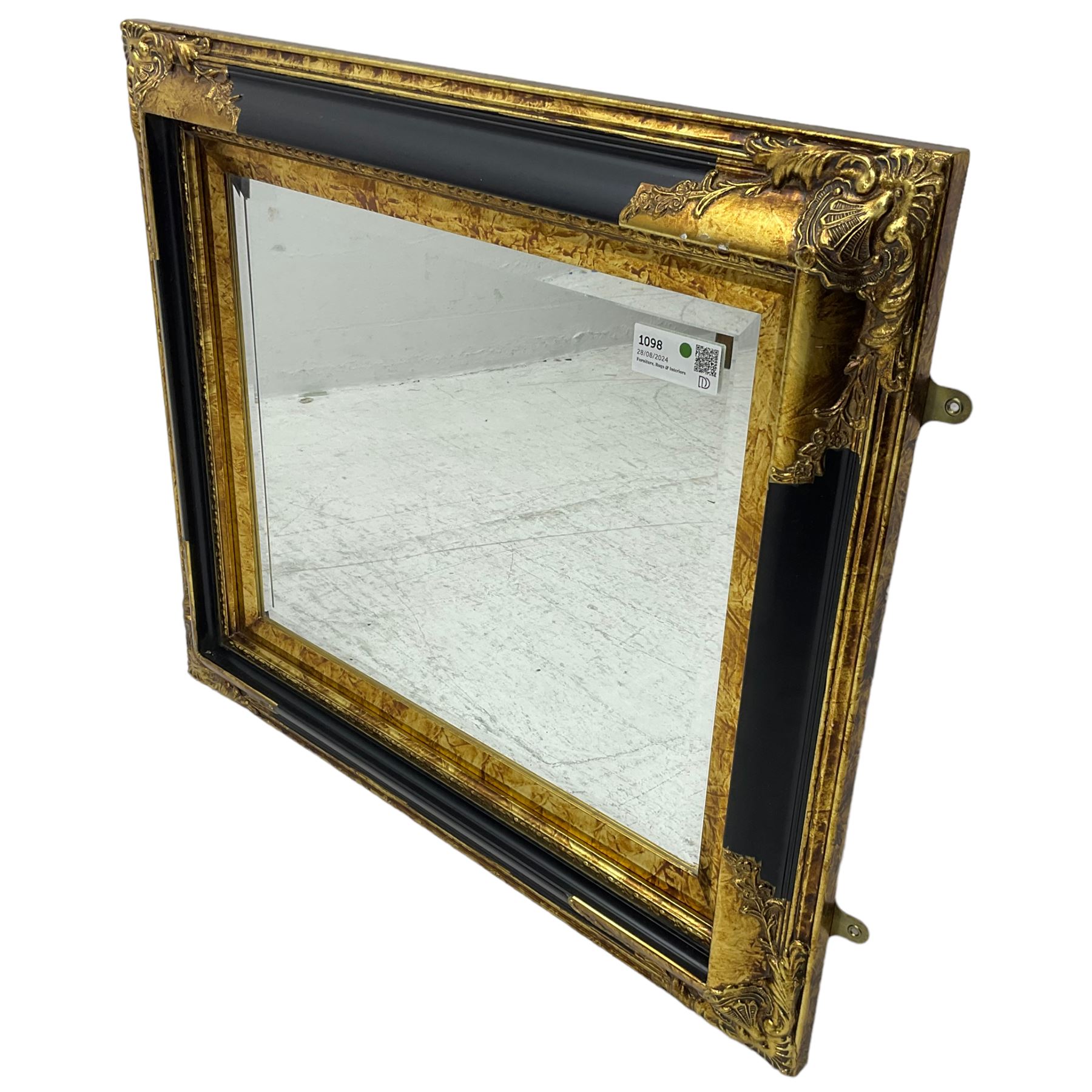 Victorian design ebonised and gilt wall mirror, the moulded rectangular frame decorated with foliate cartouches, bevelled mirror plate 