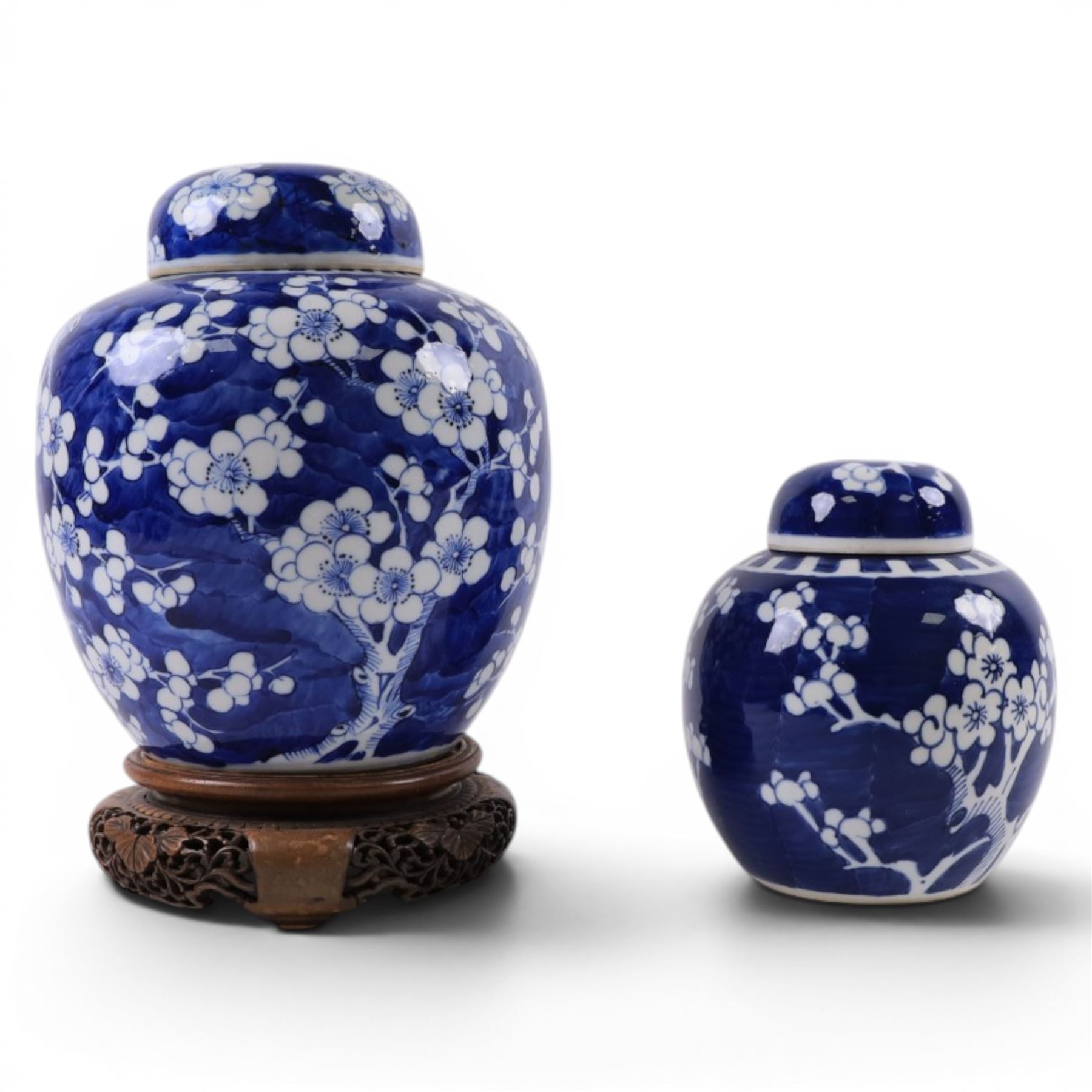 20th century Chinese blue and white porcelain prunus blossom ginger jar with cover with stand, together with another similar 