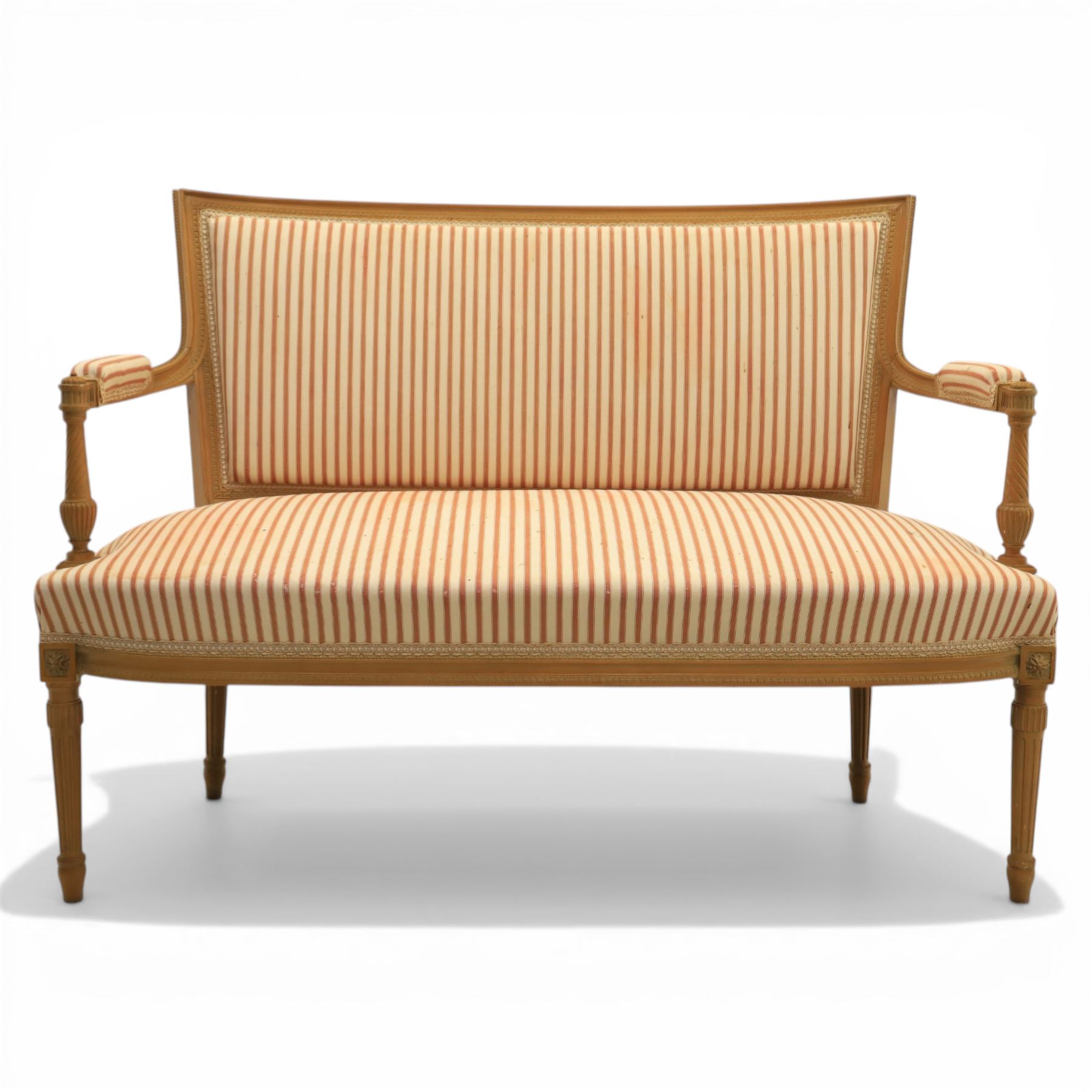 20th century Louis XVI style beech salon suite, comprising settee and four chairs, the settee with shaped rectangular back and upholstered arms over a shaped seat, the chairs with rectangular backs and overstuffed seats, each upholstered in striped fabric with close-nailed borders, upon fluted tapering supports headed by carved paterae, terminating in toupie feet, chairs H89cm W47cm
