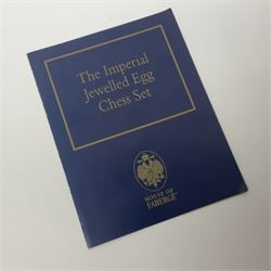 Franklin Mint House of Faberge; The Imperial Jeweled Egg Chess set, the egg opening to reveal a chess board, with a draw to the hexagonal base holding the miniature chess pieces, H23cm 