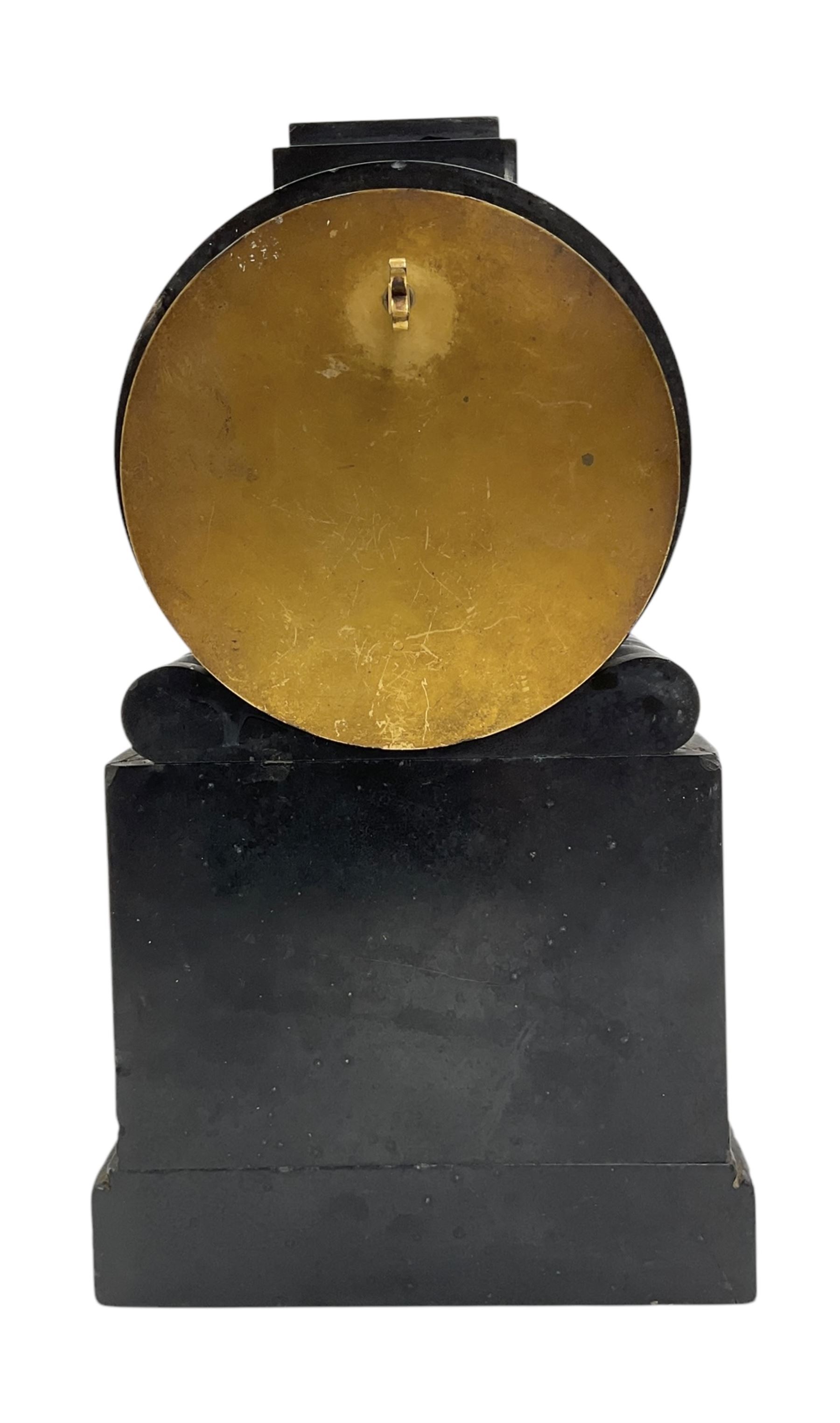 Benjamin Vulliamy of London- a small Regency 8-day ormolu and black marble mantle timepiece c1820, circular movement with a drum housing cradled on decorated scroll supports and a stepped marble plinth, the front of the plinth faintly incised with an armorial coat of arms, 3-1/2