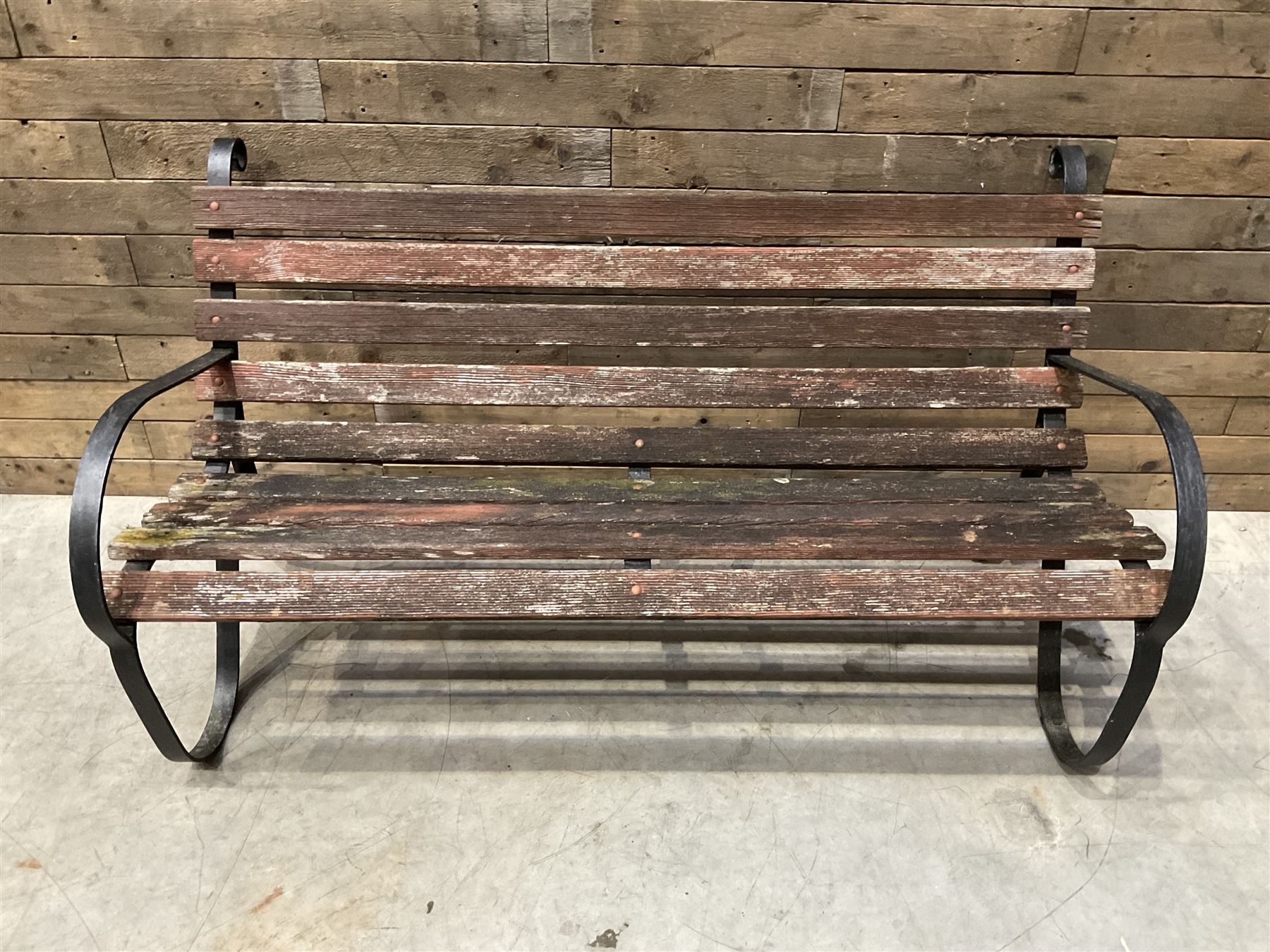 Early 20th century black painted wrought iron and wood slatted garden bench