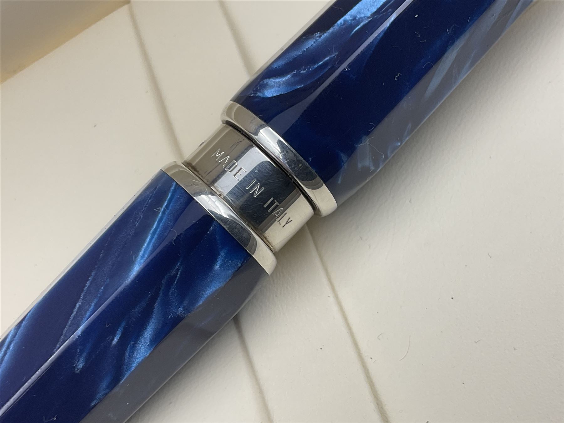 Montegrappa Emblema ball pen, the blue pearl marbled barrel of octagonal form with silver mounts and terminal with 1912 emblem, stamped 925 and clip with roller, in box, L13.5cm