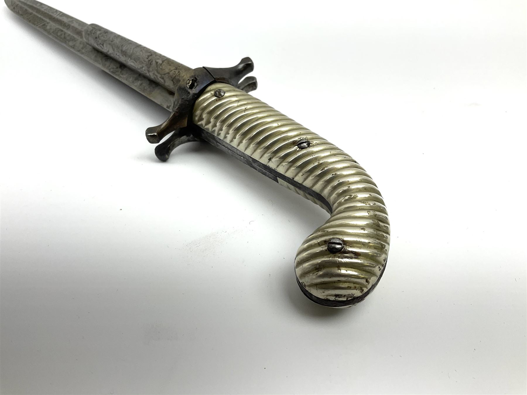 Rare double barrel percussion knife pistol by Dumonthier & Sons (NVN), approx. .38 calibre, with 8.5cm barrels and central 21.5cm spear pointed blade, all with etched damascening, upper quillons serve as hammers for the percussion ignition with single drop down trigger and fluted nickel grips, in nickel mounted leather covered tin scabbard L33.5cm overall