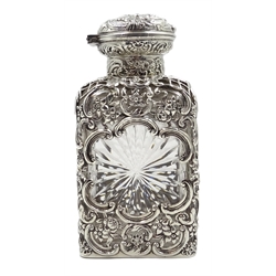  Edwardian silver mounted cut glass square decanter with star cut sides, pierced and embossed decoration with hinged push button lid, by William Comyns & Sons, London 1905  